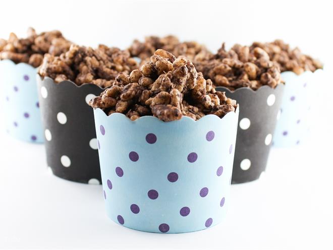 Image of pretty polka dotted blue and black colour cups filled with chocolate crackles 