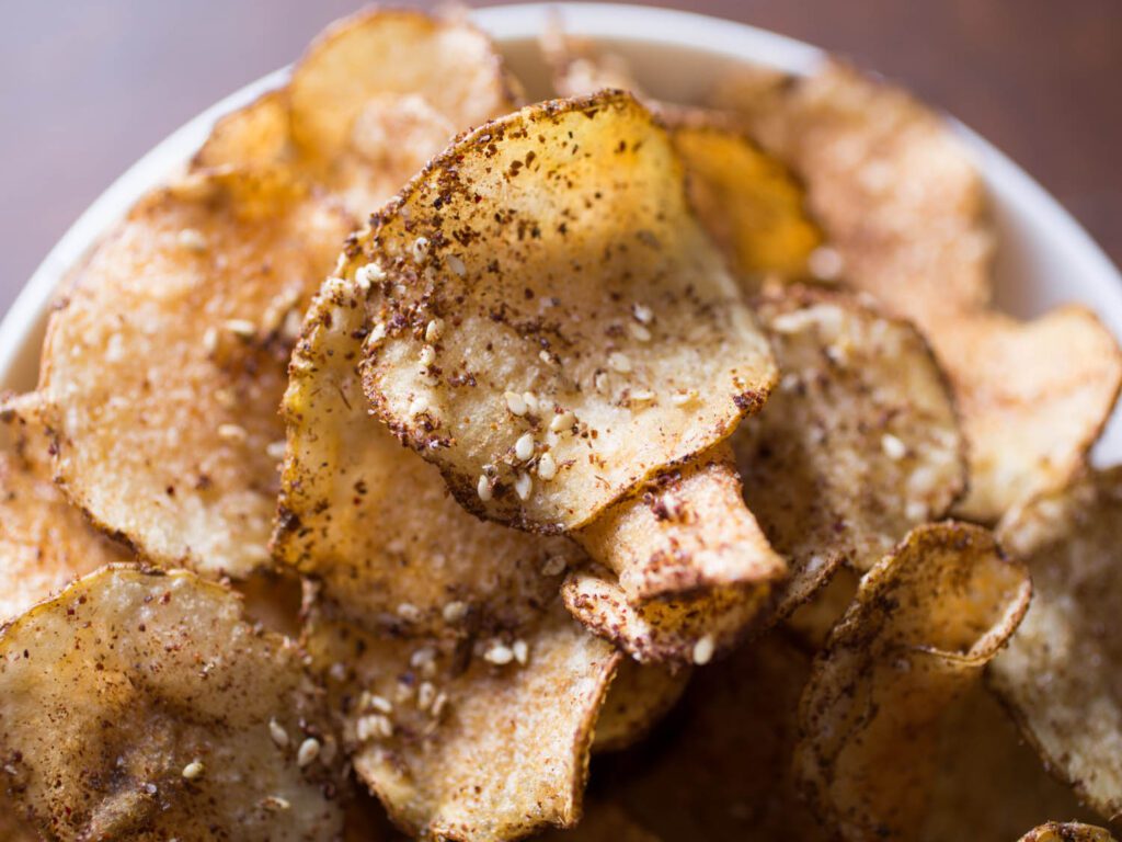 Top 10 Snacks Under 10 mins - sesame sprinkled potato chips served in a bowl.